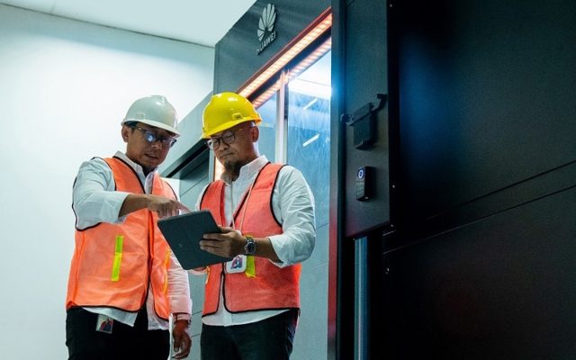 Huawei network engineers checking equipment at a deployment site