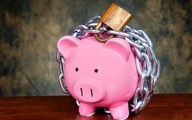 A chained padlock on a piggy bank