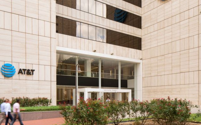 The AT&T Whitacre Tower in downtown Dallas, seen from street level, with the AT&T logo on the facade