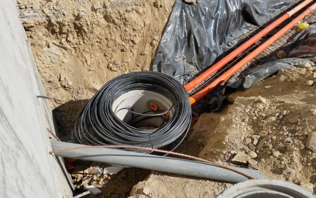 A coil of fibre optic cable laid in an open trench during installation