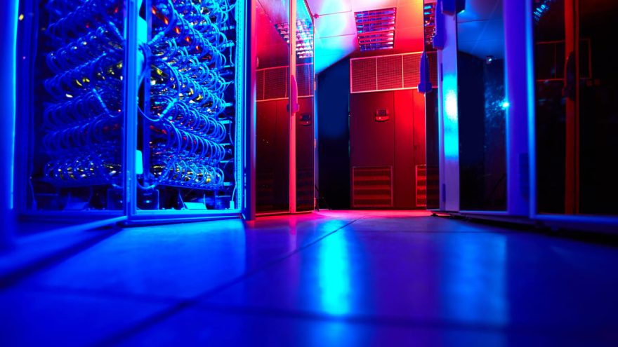 Rows of server racks inside a modern data center hall