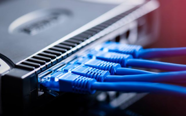 Wi-Fi router with blue ethernet cables plugged in