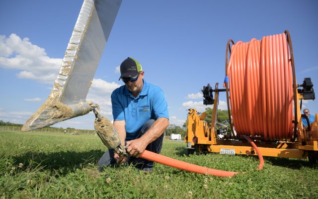 Technician working on fiber optic cable outdoors